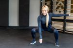 Women doing air squats in black leggings