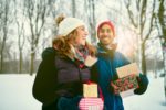 man and woman outside in winter with gifts