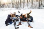 group of friends taking a selfie in the snow