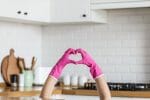 hand with rubber gloves making a heart shape