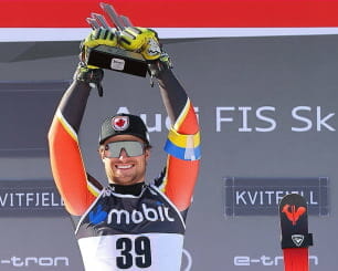 Skier holding up a trophy