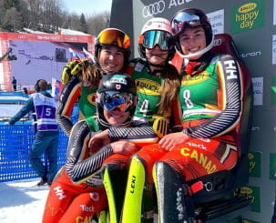 Alpine Canada skier team posing outdoors