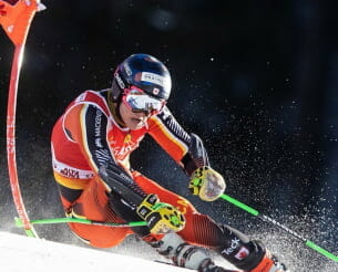 Skier racing past a gate