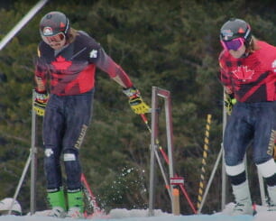 Two professional skiers at the start of a race